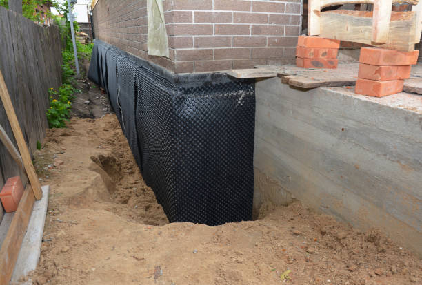 Happy homeowners after waterproofing job in Riley